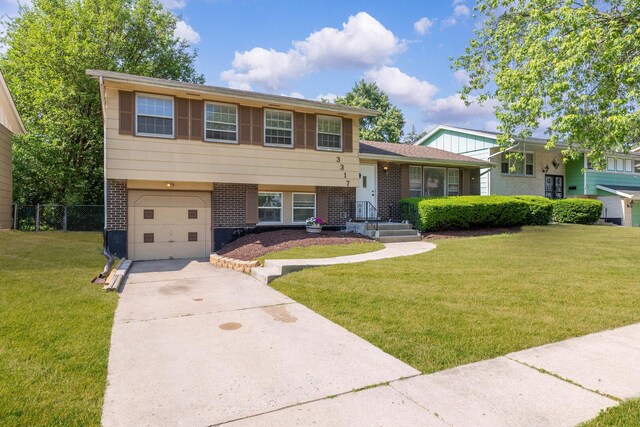 3317 Birchwood Dr, Hazel Crest, IL 60429 - tri-level home featuring brick siding, an attached garage, and driveway