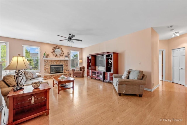 2519 Imgrund Rd, North Aurora, IL 60542 - living room featuring light wood-type flooring, plenty of natural light, ceiling fan, and a stone fireplace