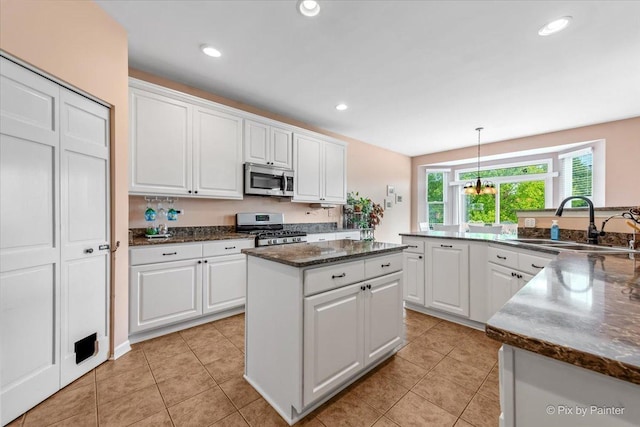 2519 Imgrund Rd, North Aurora, IL 60542 - kitchen with stainless steel appliances, a kitchen island, white cabinetry, light tile patterned floors, and recessed lighting