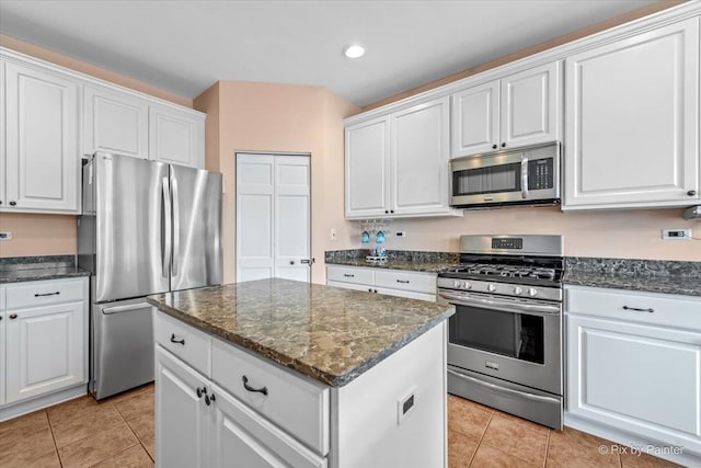 2519 Imgrund Rd, North Aurora, IL 60542 - kitchen featuring appliances with stainless steel finishes, white cabinetry, light tile patterned flooring, recessed lighting, and dark stone counters