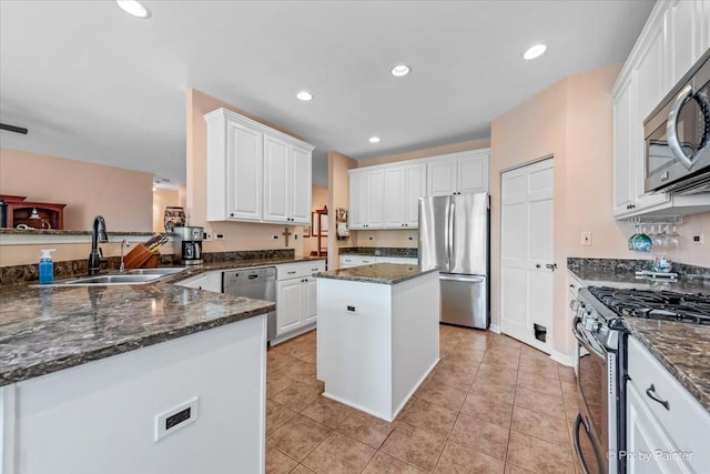 2519 Imgrund Rd, North Aurora, IL 60542 - kitchen with stainless steel appliances, white cabinetry, dark stone countertops, a kitchen island, and light tile patterned floors