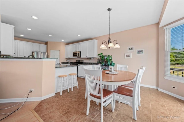 2519 Imgrund Rd, North Aurora, IL 60542 - dining space with a chandelier, light tile patterned flooring, and recessed lighting