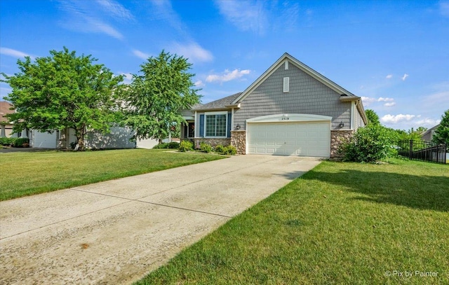 2519 Imgrund Rd, North Aurora, IL 60542 - view of front of property with stone siding, a garage, and concrete driveway