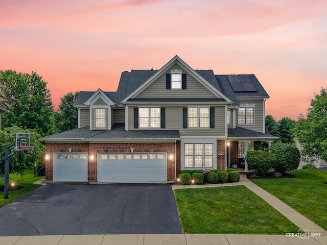 40W379 E Laura Ingalls Wilder Rd, Saint Charles, IL 60175 - traditional-style home with a front yard, driveway, roof mounted solar panels, brick siding, and an attached garage