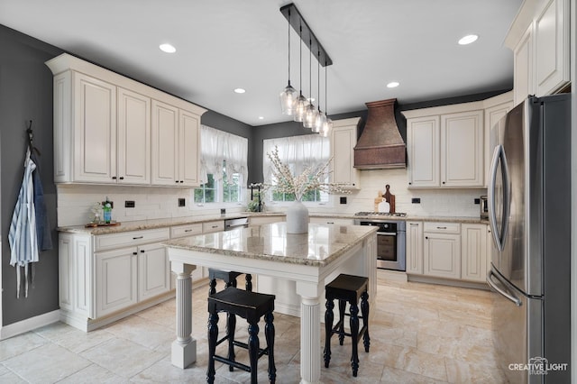 40W379 E Laura Ingalls Wilder Rd, Saint Charles, IL 60175 - kitchen featuring stainless steel appliances, custom exhaust hood, decorative backsplash, recessed lighting, and light stone countertops