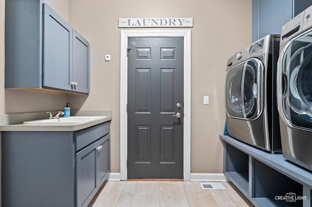 40W379 E Laura Ingalls Wilder Rd, Saint Charles, IL 60175 - laundry room with washer and dryer, cabinet space, and light wood finished floors