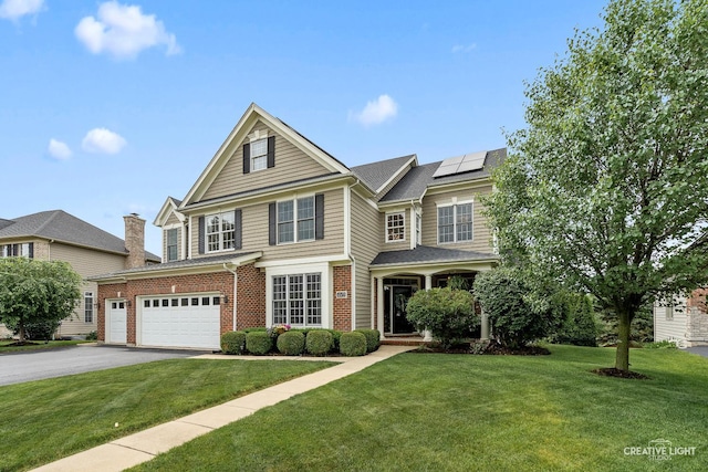 40W379 E Laura Ingalls Wilder Rd, Saint Charles, IL 60175 - traditional home featuring roof mounted solar panels, an attached garage, and a front lawn