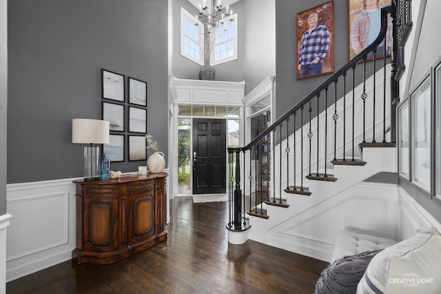 40W379 E Laura Ingalls Wilder Rd, Saint Charles, IL 60175 - foyer with a towering ceiling, a chandelier, a wainscoted wall, stairs, and wood finished floors