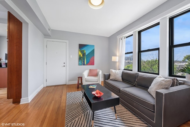 2709 W Belden Ave Unit 3, Chicago, IL 60647 - living room featuring baseboards and light wood-style flooring