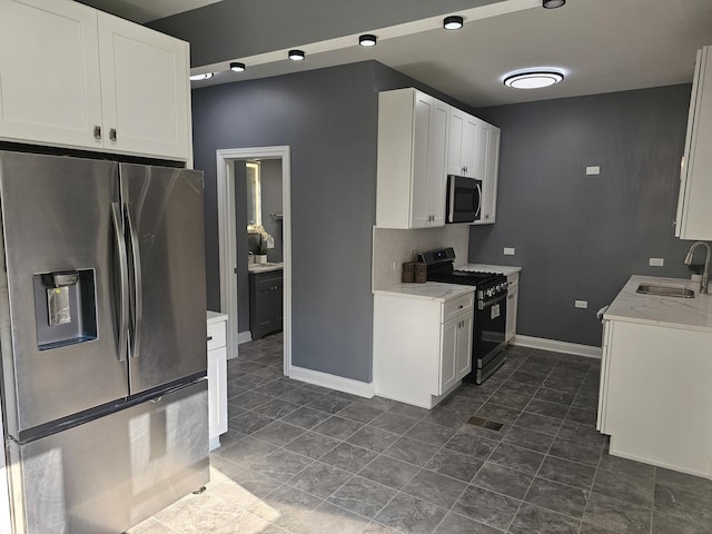 12136 S Wentworth Ave, Chicago, IL 60628 - kitchen featuring stainless steel appliances, white cabinets, light stone counters, and dark tile patterned floors