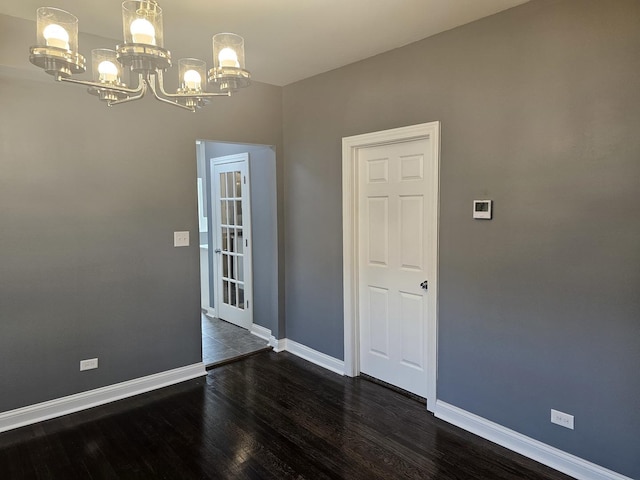 12136 S Wentworth Ave, Chicago, IL 60628 - unfurnished room featuring a chandelier and dark wood finished floors