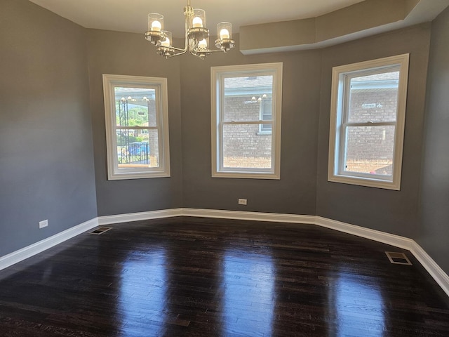 12136 S Wentworth Ave, Chicago, IL 60628 - empty room featuring dark wood-type flooring and a chandelier