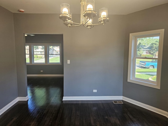 12136 S Wentworth Ave, Chicago, IL 60628 - unfurnished room featuring a chandelier, dark wood finished floors, plenty of natural light, and a smoke detector