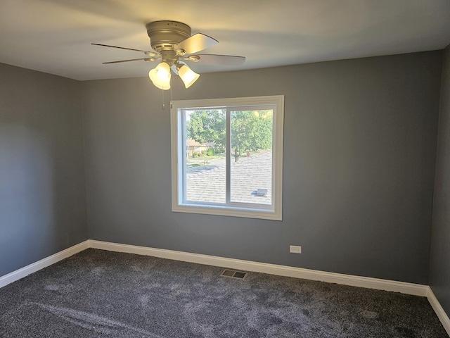 12136 S Wentworth Ave, Chicago, IL 60628 - empty room featuring dark carpet and ceiling fan