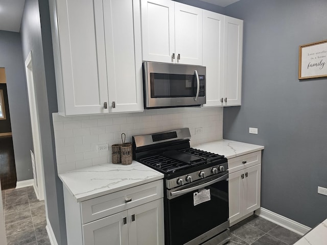 12136 S Wentworth Ave, Chicago, IL 60628 - kitchen with stainless steel appliances, backsplash, light stone counters, and white cabinetry