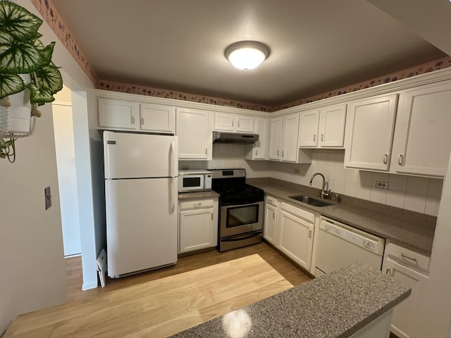900 E Wilmette Rd Unit 411, Palatine, IL 60074 - kitchen with white appliances, under cabinet range hood, dark countertops, white cabinetry, and wood finished floors