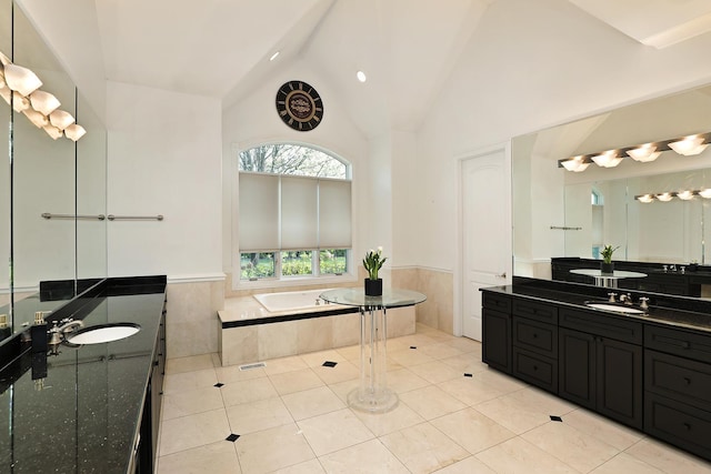 1630 Ridge Rd, Highland Park, IL 60035 - bathroom featuring a wainscoted wall, two vanities, a bath, lofted ceiling, and tile patterned flooring