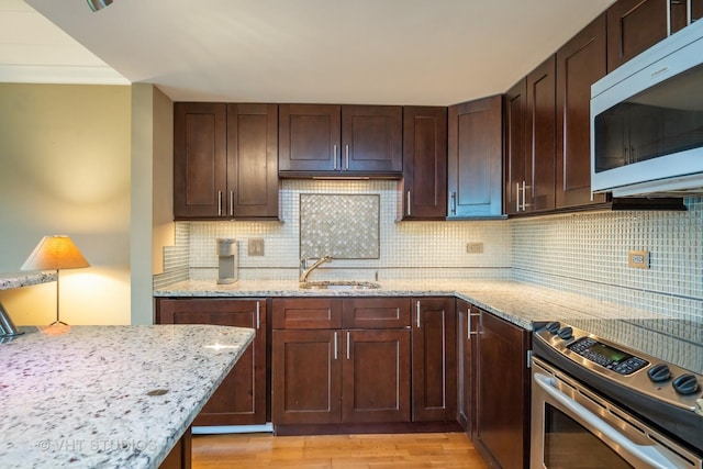 100 Deborah Ln Unit B23, Wheeling, IL 60090 - kitchen with stainless steel electric range, decorative backsplash, light stone counters, light wood-style floors, and dark brown cabinets