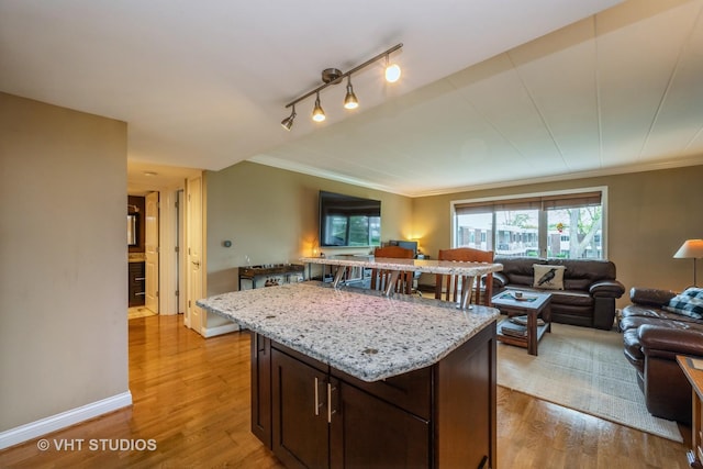 100 Deborah Ln Unit B23, Wheeling, IL 60090 - kitchen featuring open floor plan, light wood-style floors, light stone countertops, and ornamental molding