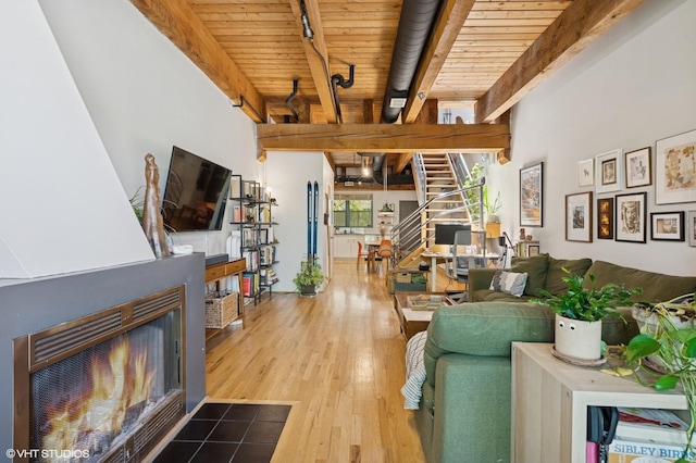 1740 N Marshfield Ave Unit 29, Chicago, IL 60622 - living area with a wood ceiling with exposed beams, hardwood / wood-style floors, stairway, track lighting, and a fireplace with flush hearth