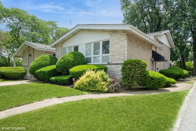 4841 W Lunt Ave, Lincolnwood, IL 60712 - view of side of property with a yard, stone siding, and brick siding