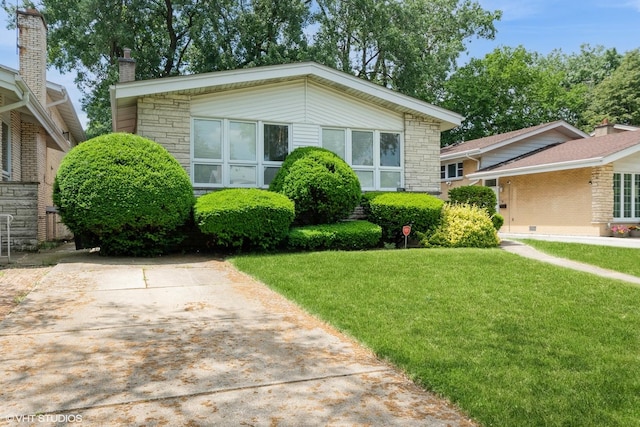 4841 W Lunt Ave, Lincolnwood, IL 60712 - view of front of property featuring a front yard, a chimney, and stone siding