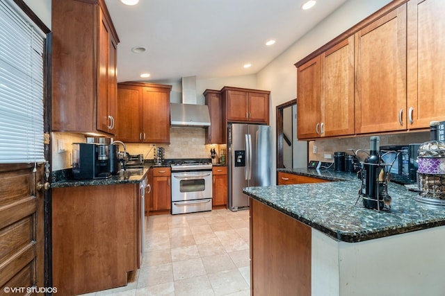 4841 W Lunt Ave, Lincolnwood, IL 60712 - kitchen with appliances with stainless steel finishes, wall chimney exhaust hood, tasteful backsplash, a peninsula, and dark stone counters