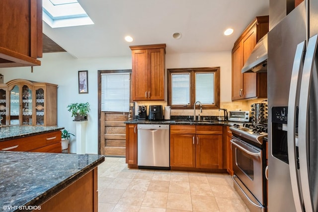 4841 W Lunt Ave, Lincolnwood, IL 60712 - kitchen with appliances with stainless steel finishes, a skylight, brown cabinetry, and recessed lighting