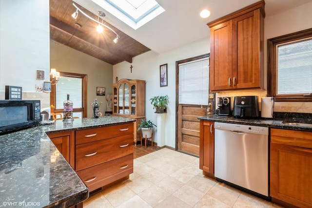 4841 W Lunt Ave, Lincolnwood, IL 60712 - kitchen with stainless steel dishwasher, black microwave, vaulted ceiling, a skylight, and brown cabinetry