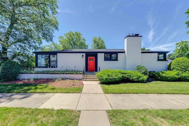 4021 W Estes Ave, Lincolnwood, IL 60712 - mid-century inspired home featuring a chimney and a front lawn