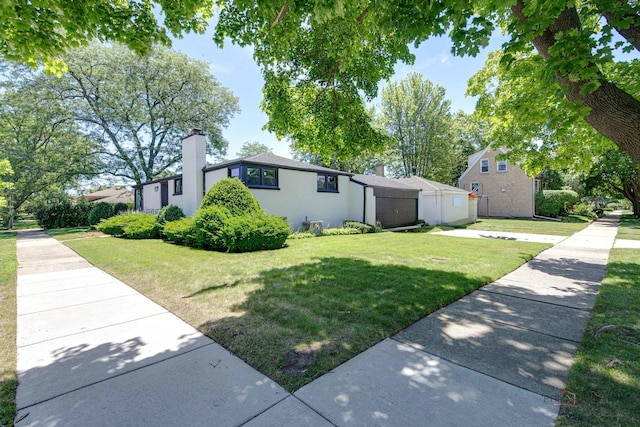 4021 W Estes Ave, Lincolnwood, IL 60712 - view of front of property with a front yard and a chimney