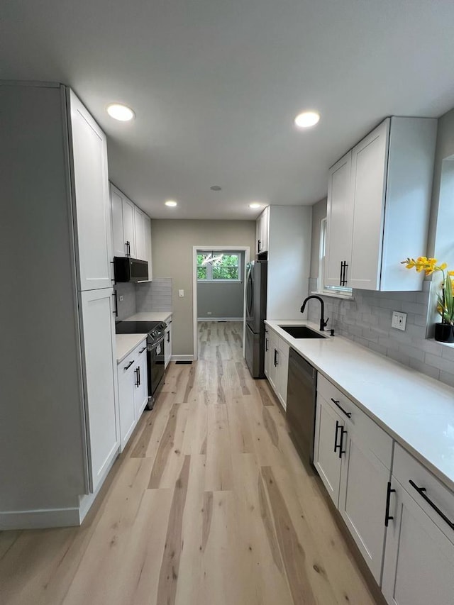 4021 W Estes Ave, Lincolnwood, IL 60712 - kitchen featuring dishwashing machine, electric range oven, freestanding refrigerator, light wood finished floors, and decorative backsplash