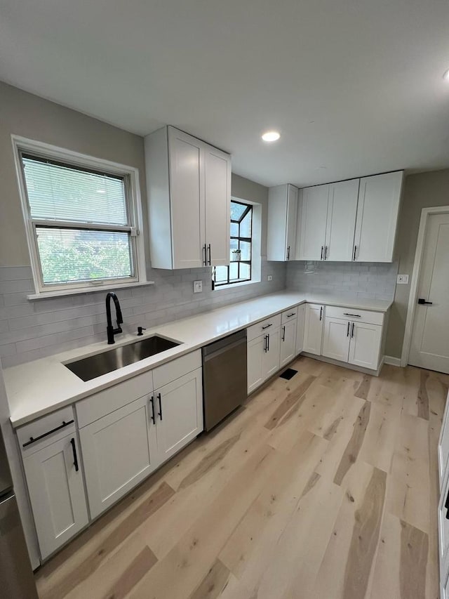 4021 W Estes Ave, Lincolnwood, IL 60712 - kitchen featuring dishwasher, backsplash, light wood-style flooring, light countertops, and recessed lighting