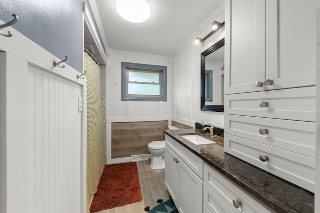 2839 School St, Flossmoor, IL 60422 - bathroom featuring vanity, crown molding, wood finished floors, and a decorative wall