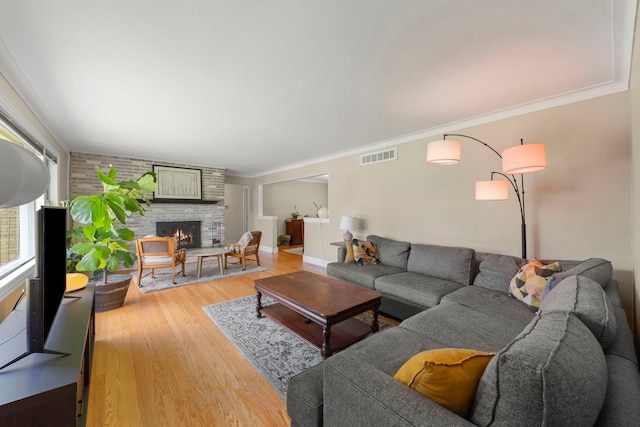2839 School St, Flossmoor, IL 60422 - living room with light wood-style floors, a brick fireplace, and ornamental molding