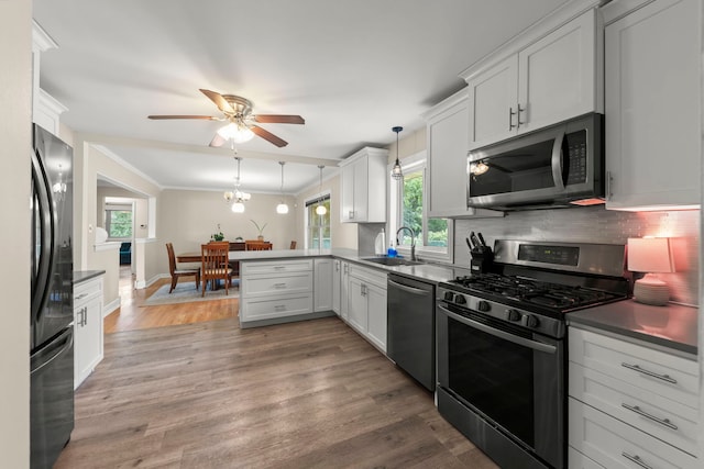 2839 School St, Flossmoor, IL 60422 - kitchen featuring appliances with stainless steel finishes, a ceiling fan, a peninsula, tasteful backsplash, and hanging light fixtures