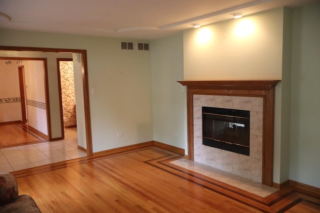 19443 Trenton Way, Mokena, IL 60448 - unfurnished living room with light wood-type flooring and a tile fireplace