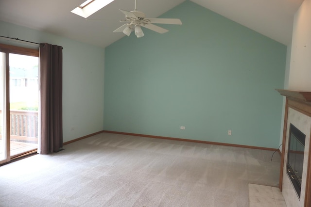 19443 Trenton Way, Mokena, IL 60448 - unfurnished living room with a skylight, light colored carpet, vaulted ceiling, a ceiling fan, and a fireplace with flush hearth
