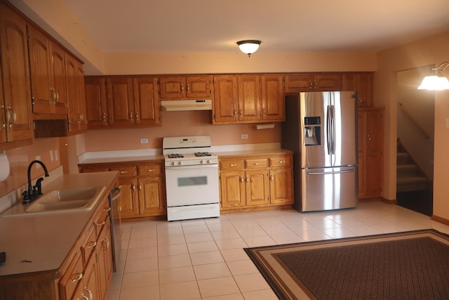19443 Trenton Way, Mokena, IL 60448 - kitchen with appliances with stainless steel finishes, under cabinet range hood, brown cabinets, light tile patterned floors, and light countertops