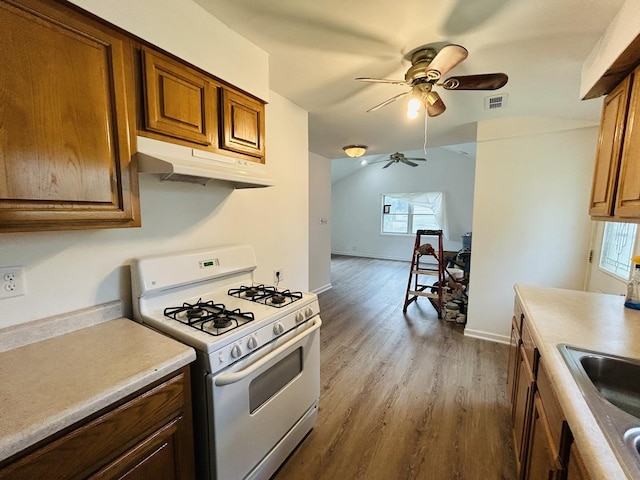 37706 N Nippersink Pl, Spring Grove, IL 60081 - kitchen featuring white gas range, under cabinet range hood, ceiling fan, dark wood-style floors, and light countertops