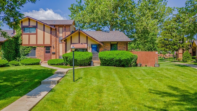 1S222 Danby St, Villa Park, IL 60181 - tudor house featuring brick siding, a front yard, a shingled roof, and stucco siding