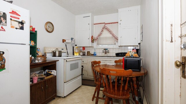 312 N Mclean St, Bloomington, IL 61701 - kitchen featuring white appliances, white cabinets, light flooring, and decorative backsplash