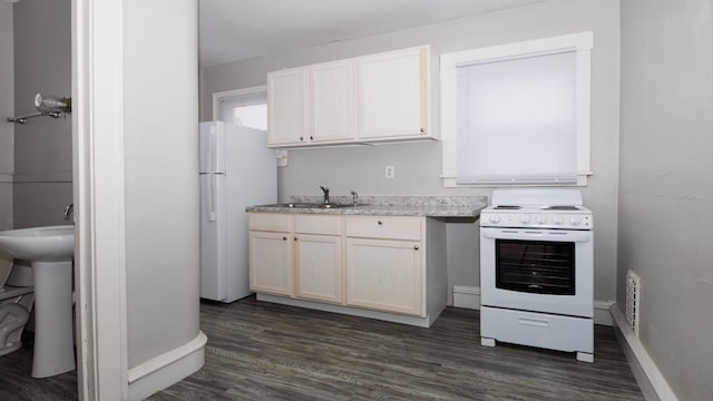 312 N Mclean St, Bloomington, IL 61701 - kitchen with white appliances, dark wood-style floors, and white cabinets