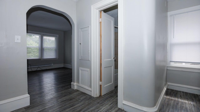 312 N Mclean St, Bloomington, IL 61701 - hallway featuring wood finished floors, a baseboard radiator, and arched walkways