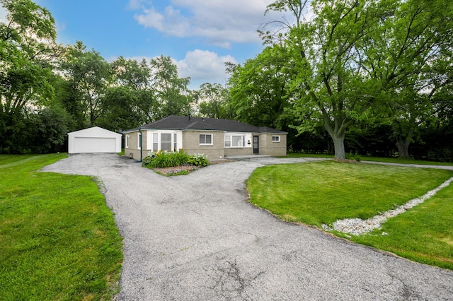 1055 N Bluebonnet Ln, Hoffman Estates, IL 60169 - ranch-style home featuring an outbuilding, a garage, a front lawn, and view of scattered trees