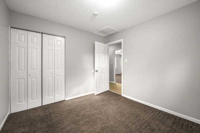 1055 N Bluebonnet Ln, Hoffman Estates, IL 60169 - unfurnished bedroom featuring dark colored carpet, attic access, and a closet