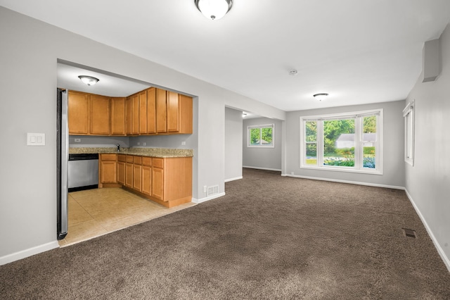 1055 N Bluebonnet Ln, Hoffman Estates, IL 60169 - kitchen featuring dishwasher, light colored carpet, open floor plan, light countertops, and brown cabinets