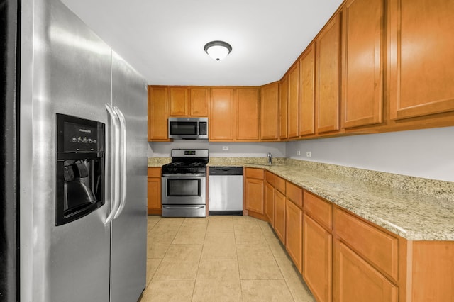 1055 N Bluebonnet Ln, Hoffman Estates, IL 60169 - kitchen with appliances with stainless steel finishes, light tile patterned floors, brown cabinets, and light stone counters