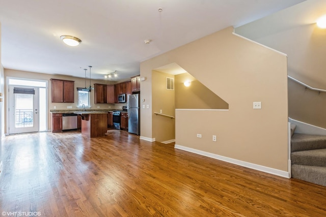 1240 W Monroe St Unit 7, Chicago, IL 60607 - kitchen featuring stainless steel appliances, open floor plan, dark wood-style flooring, and a center island