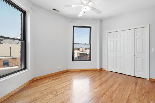 2332 W Huron St Unit 4, Chicago, IL 60612 - unfurnished bedroom featuring light wood finished floors, a closet, and ceiling fan